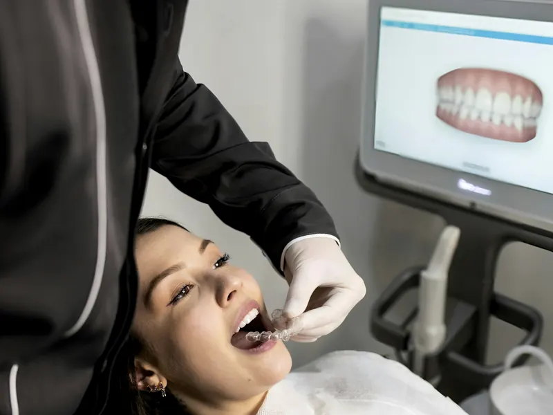 Dentist examining a patient with a dental scanner