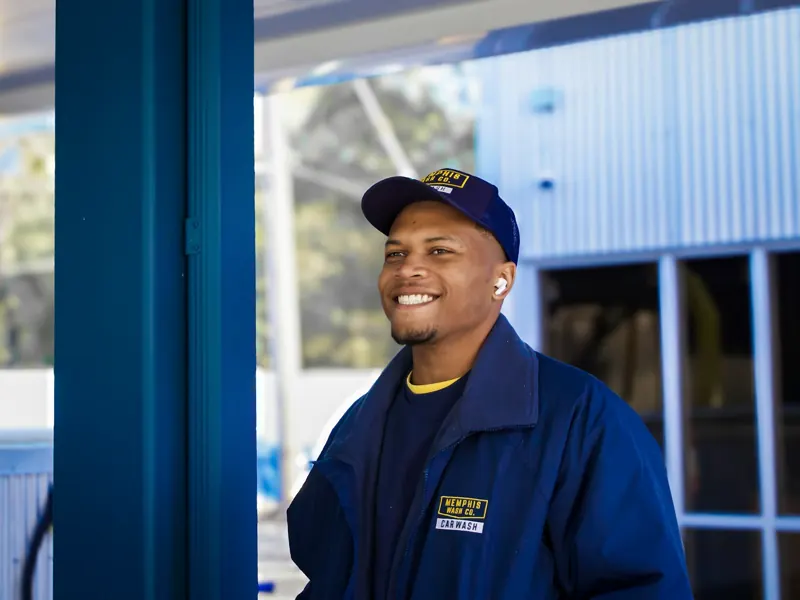 Smiling HVAC technician in a blue work uniform